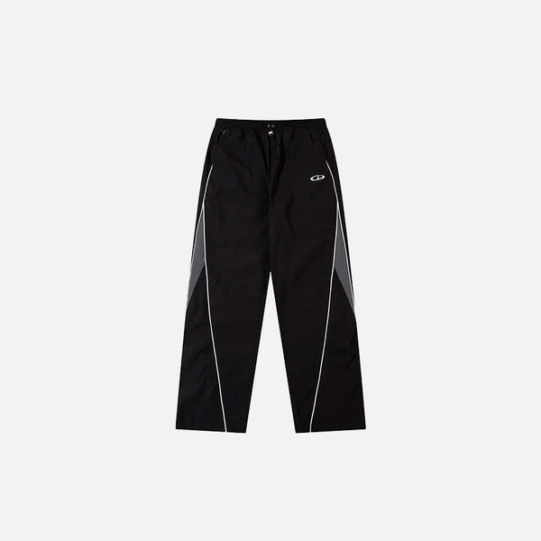 Front view of the Y2K Black Patchwork Sports Pants in a gray background