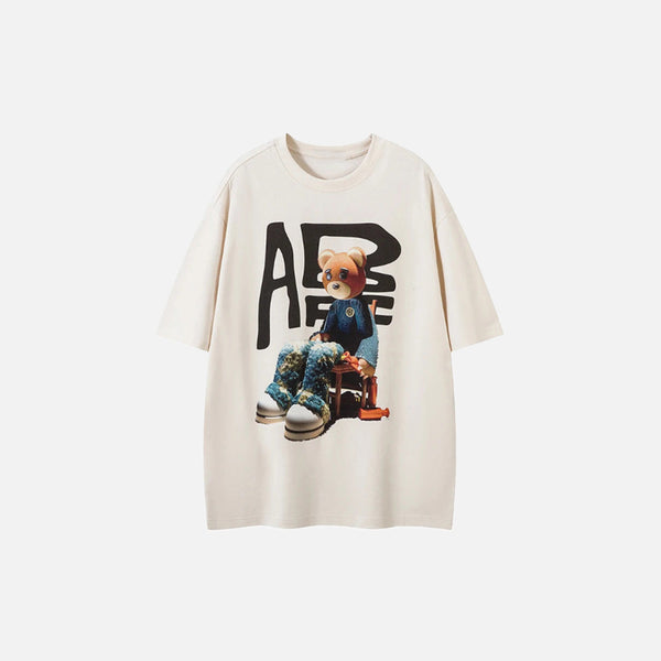 Front view of the beige Bear Essence T-shirt in a gray background
