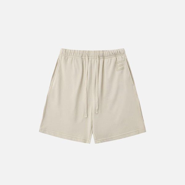 Front view of the beige Letter Print Loose Shorts in a gray background