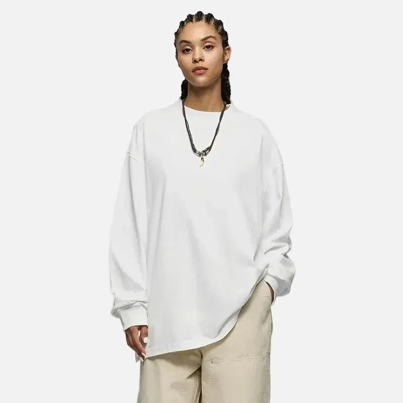 Moel wearing the white Oversized Luxe T-Shirt in a gray background