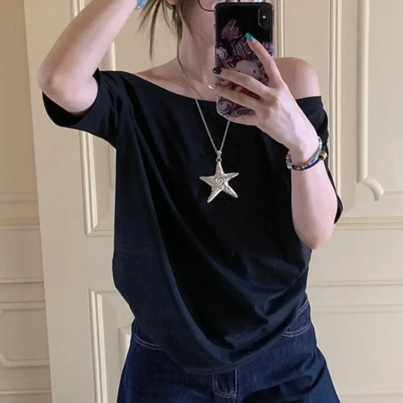 Model wearing the black Relaxed Off-Shoulder T-Shirt