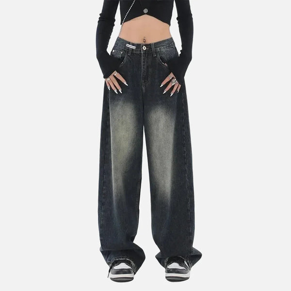 Model wearing the deep blue Vintage Washed Denim Jeans in a gray background