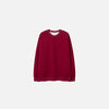Front view of the red Classic Crewneck Sweater in a gray background