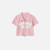 Front view of the pink Women's Retro Graphic Polo Shirt in a gray background