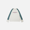 Front view of the apricot Aero-Emblem Sweatshirt in a gray background