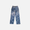 Front view of the blue Patchwork Textured Jeans in a gray background