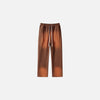 Front view of the brown Casual Noir Relax Pants in a gray background