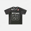 Front view of the black Patchwork Graphic Printed T-Shirt n a gray background