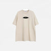 Front view of the beige Patchwork Embroidered Eye T-Shirt in a gray background