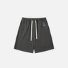 Front view of the dark gray Letter Print Loose Shorts in a gray background