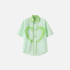 Front view of the Green Heart Graffiti Women's Shirt in a gray background