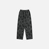 Front view of the black Patchwork Textured Jeans in a gray background
