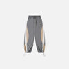 Front view of the gray Y2K Patchwork Joggers Baggy Pants in a gray background