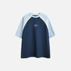 Front view of the blue Classic Raglan T-shirt in a gray background