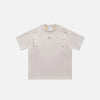 Front view of the beige Vintage Metal Patchwork T-shirt in a gray background