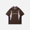 Front view of the brown Vintage Sports Patchwork Polo T-Shirt in a gray background 