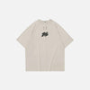 Front view of the beige Sleek Mono Logo T-shirt in a gray background