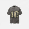 Front view of the grey Vintage Grunge Patch T-Shirt in a gray background