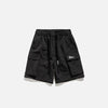 Front view of the black Essential Utility Cargo Shorts in a gray background