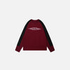 Front view of the red Aero-Emblem Sweatshirt in a gray background