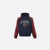 Front view of the blue BlackAir Crest Hoodie in a gray background