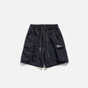 Front view of the navy Essential Utility Cargo Shorts in a gray background