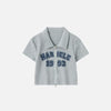 Front view of the grey Women's Retro Graphic Polo Shirt in a gray background