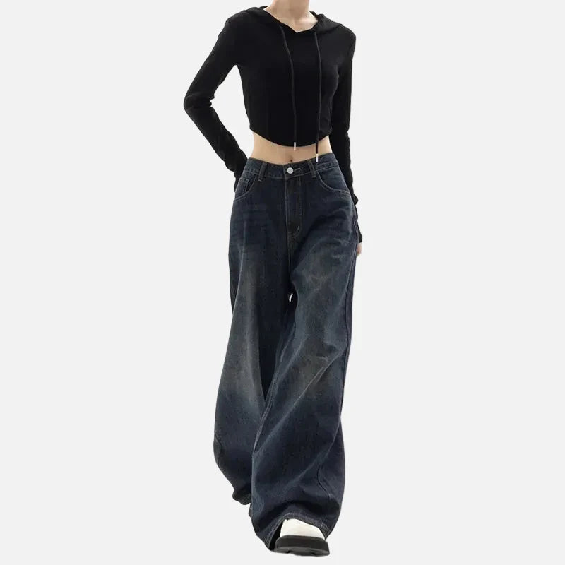 Model wearing the blue Ultra Baggy Denim Jeans in a gray background