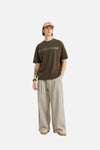 Model wearing the khaki Loose Retro Solid Pants in a gray background 