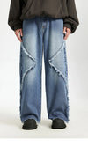 Model wearing the blue Frayed Flow Jeans in a gray background