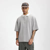 Model wearing the gray Placket Polo T-Shirt in a gray background